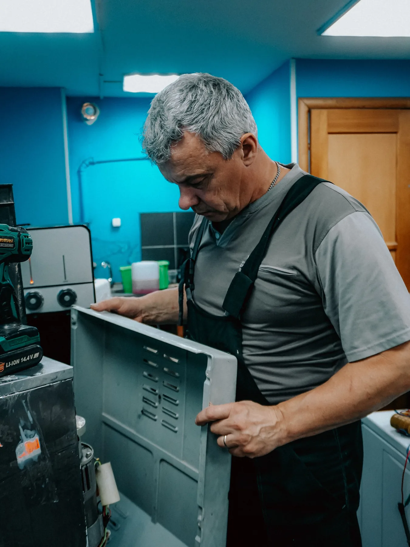 Repair technician inspecting a home appliance