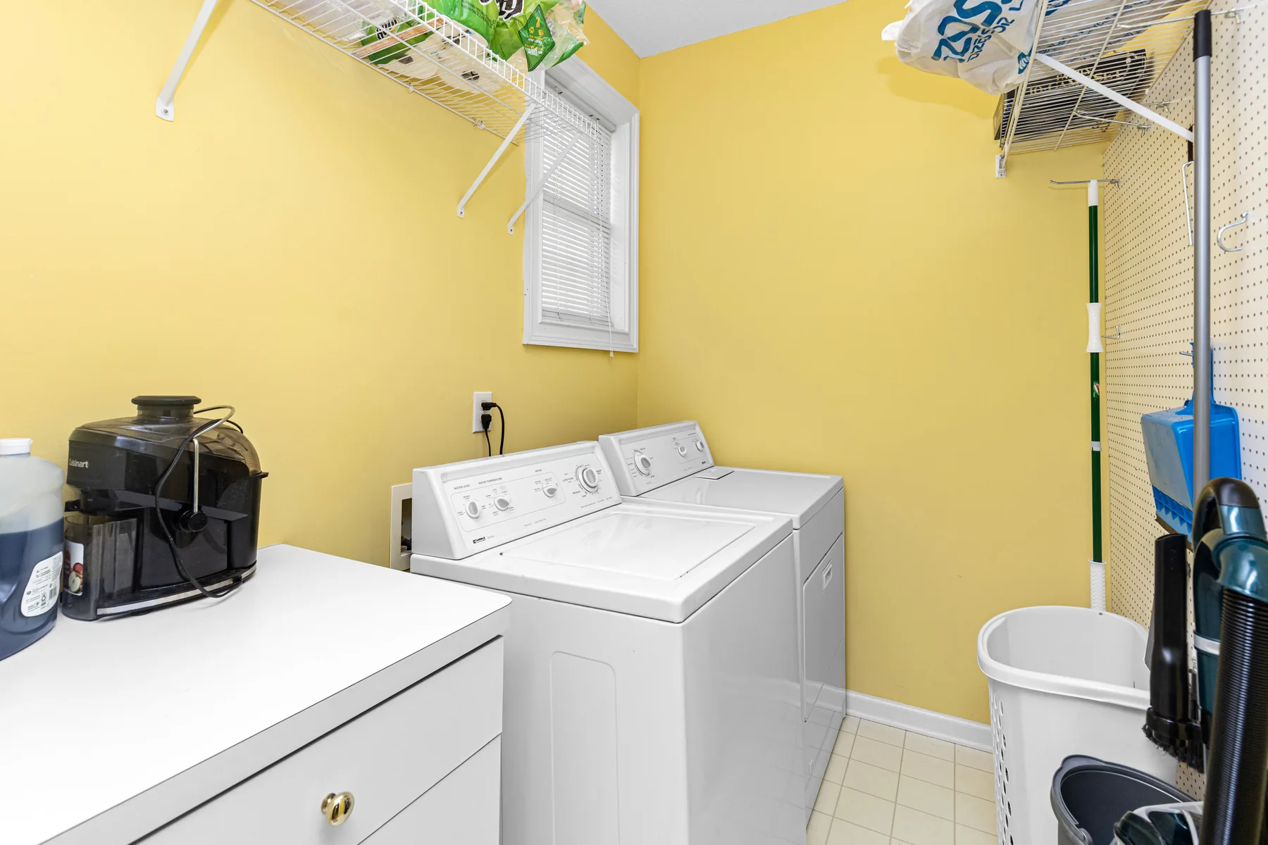 Bright home laundry room with washing appliances